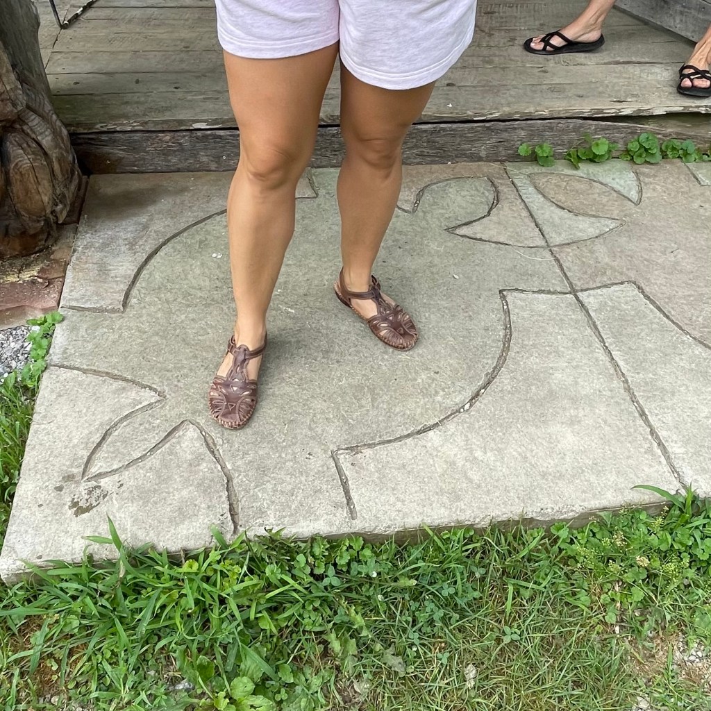 Celena stands on a turtle image.