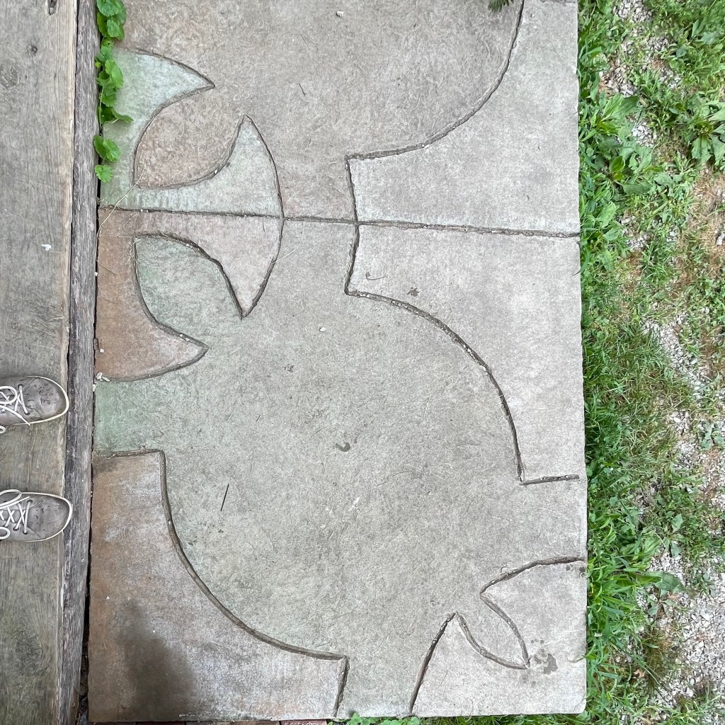 A turtle engraved in cement.
